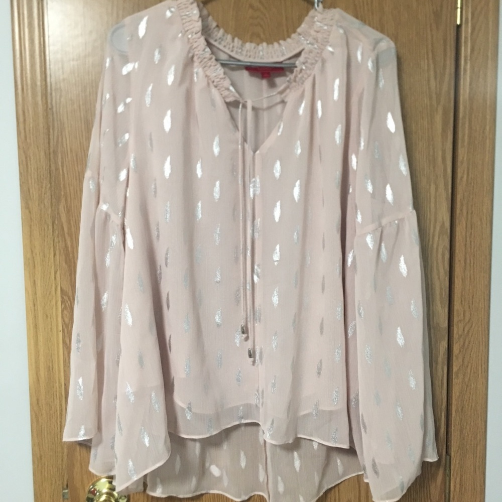 Jennifer Lopez light pink blouse.